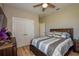 Bright bedroom with double doors and wood-look flooring at 600 Nasturtium Ct, Nokomis, FL 34275