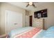 Bedroom with a queen-size bed, mounted TV, and double doors closet at 600 Nasturtium Ct, Nokomis, FL 34275