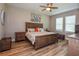 Spacious bedroom with a wooden bed frame and coastal-themed bedding at 600 Nasturtium Ct, Nokomis, FL 34275