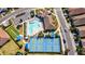 Aerial view of community pool and tennis courts at 600 Nasturtium Ct, Nokomis, FL 34275