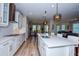 Modern kitchen with white cabinets and a large island at 600 Nasturtium Ct, Nokomis, FL 34275