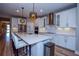 Modern kitchen with white cabinets, stainless steel appliances, and large island at 600 Nasturtium Ct, Nokomis, FL 34275