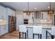 Modern kitchen with white cabinets, island, and stainless steel appliances at 600 Nasturtium Ct, Nokomis, FL 34275