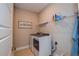 Laundry room with washer, dryer, and ample shelving at 600 Nasturtium Ct, Nokomis, FL 34275