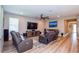 Living room with hardwood floors and large TV at 600 Nasturtium Ct, Nokomis, FL 34275