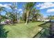 Expansive backyard featuring lush green lawn and tropical landscaping, perfect for outdoor entertaining at 612 Cadiz Rd, Venice, FL 34285