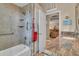 Bathroom featuring glass enclosed shower and tub combo, granite counters and modern fixtures at 612 Cadiz Rd, Venice, FL 34285