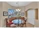 Charming breakfast nook featuring a glass table, upholstered seating, and bright natural light at 612 Cadiz Rd, Venice, FL 34285