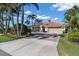 Attractive exterior featuring a tile roof, attached garage, and a neatly landscaped yard at 612 Cadiz Rd, Venice, FL 34285