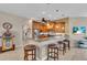 Kitchen featuring bar seating, wood cabinets, and modern stainless steel appliances at 612 Cadiz Rd, Venice, FL 34285