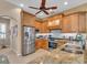 Bright kitchen features granite counters, wood cabinets, and stainless steel appliances at 612 Cadiz Rd, Venice, FL 34285