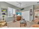 Cozy living room featuring tile floors, comfortable seating, and a ceiling fan at 612 Cadiz Rd, Venice, FL 34285