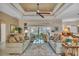 Living room with two sofas, large windows, a ceiling fan and a neutral color palette at 612 Cadiz Rd, Venice, FL 34285