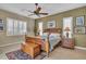 Serene bedroom with neutral tones, plantation shutters, ceiling fan and custom furnishings at 612 Cadiz Rd, Venice, FL 34285