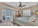 Tranquil bedroom with neutral tones, access to pool, plantation shutters and ceiling fan at 612 Cadiz Rd, Venice, FL 34285