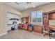 Another view of the spacious office with built-in desks, cabinets, and natural light at 612 Cadiz Rd, Venice, FL 34285