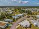 Aerial shot of a home in a well-maintained 55+ community with mature trees, landscaping and well-kept streets at 6462 Haele Ct, North Port, FL 34287