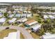 Aerial view of community showcasing manufactured homes, landscaping, driveways, and street layouts at 6462 Haele Ct, North Port, FL 34287