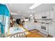 Bright kitchen featuring white cabinets, stainless steel appliances, and an adjacent dinette at 6462 Haele Ct, North Port, FL 34287