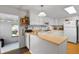 Charming kitchen features white cabinets, a stainless steel microwave and a double basin sink at 6462 Haele Ct, North Port, FL 34287