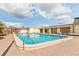 Community pool surrounded by lounge chairs under a partly cloudy sky at 6462 Haele Ct, North Port, FL 34287