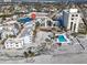 Overhead angle of a condo community featuring a pool, tennis courts, and beautiful beach views at 700 Golden Beach Blvd # 221, Venice, FL 34285