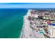 Stunning aerial view of beachside condos with pool and the Gulf's turquoise waters and sandy beach at 700 Golden Beach Blvd # 221, Venice, FL 34285