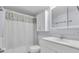 Bright bathroom features white vanity, cabinet, and shower with colorful curtain at 700 Golden Beach Blvd # 221, Venice, FL 34285