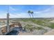 Convenient beach access includes shower and bench with view of palm trees and the ocean at 700 Golden Beach Blvd # 221, Venice, FL 34285