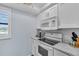 Modern kitchen featuring white appliances, countertops, and cabinetry, with a window at 700 Golden Beach Blvd # 221, Venice, FL 34285