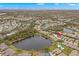 Aerial view of a townhome community with a lake and lush trees at 7145 Lakeside Dr, Sarasota, FL 34243