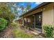 Back exterior of the villa, featuring a private screened-in lanai and lush landscaping at 7145 Lakeside Dr, Sarasota, FL 34243