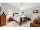 Comfortable bedroom featuring a ceiling fan, window with shutters, and wood furniture at 7145 Lakeside Dr, Sarasota, FL 34243