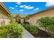 Charming villa entryway with lush landscaping creating a welcoming approach to the front door at 7145 Lakeside Dr, Sarasota, FL 34243