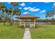 Picturesque gazebo overlooking the lake surrounded by lush landscaping and a serene setting at 7145 Lakeside Dr, Sarasota, FL 34243