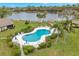 Community pool area with a view of the lake and surrounding greenery at 7145 Lakeside Dr, Sarasota, FL 34243