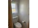 A standard toilet in a small bathroom with a window at 718 Roma Rd, Venice, FL 34285