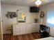 Bedroom featuring dresser, mounted TV, and hat rack at 718 Roma Rd, Venice, FL 34285