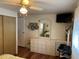 Bedroom featuring dresser, mirror, mounted TV, and closet at 718 Roma Rd, Venice, FL 34285