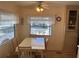 Light and airy dining room with natural lighting, seating for four, and ceiling fan at 718 Roma Rd, Venice, FL 34285