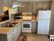 Functional kitchen featuring appliances, tiled backsplash, and ample cabinet space at 718 Roma Rd, Venice, FL 34285