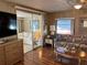 Living room featuring sliding doors to the lanai and an adjacent seating area at 718 Roma Rd, Venice, FL 34285