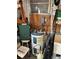 Storage room featuring a standard water heater with surrounding tools and equipment at 718 Roma Rd, Venice, FL 34285