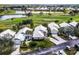 Aerial view of the homes and golf course community featuring well-maintained landscaping and serene water features at 734 Brightside Crescent Dr # 18, Venice, FL 34293