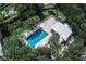 Aerial view of the community pool surrounded by trees, creating a private and relaxing outdoor space at 734 Brightside Crescent Dr # 18, Venice, FL 34293