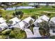 Aerial view of homes near a golf course and pond, showcasing manicured lawns and mature trees at 734 Brightside Crescent Dr # 18, Venice, FL 34293