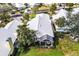 Aerial view highlighting property with lush backyard, screened lanai, and a manicured lawn at 734 Brightside Crescent Dr # 18, Venice, FL 34293