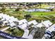 Aerial view of real estate showcasing lush greenery, a pond, golf course, and residential neighborhood at 734 Brightside Crescent Dr # 18, Venice, FL 34293