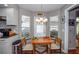 Cozy breakfast nook featuring a chandelier, natural light, and wood floors at 734 Brightside Crescent Dr # 18, Venice, FL 34293