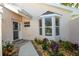 Charming front entrance features a bay window, a colorful garden, and a walkway at 734 Brightside Crescent Dr # 18, Venice, FL 34293